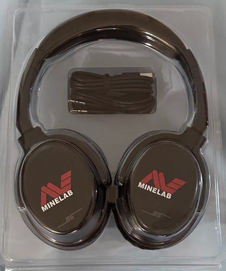 A black headphones in a plastic package  Description automatically generated